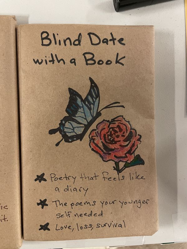 A hand-drawn wrapped book showing a butterfly and a rose, with hints about a poetry collection.